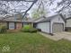 Inviting home with brick and grey siding, featuring a two-car garage and landscaped front yard at 9118 Lansburgh Ct, Indianapolis, IN 46234