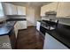 Modern kitchen featuring white cabinets, stainless steel appliances, and dark countertops at 9118 Lansburgh Ct, Indianapolis, IN 46234