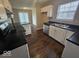 Well-lit kitchen with white cabinetry, stainless steel appliances, and dark countertops at 9118 Lansburgh Ct, Indianapolis, IN 46234