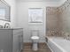 Clean bathroom with a modern vanity, tiled shower, and window for natural light at 917 S Grant St, Muncie, IN 47302