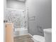 Well-lit bathroom featuring mosaic tile accent wall, shower, and modern fixtures at 917 S Grant St, Muncie, IN 47302