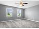 Comfortable bedroom featuring two windows and neutral color scheme at 917 S Grant St, Muncie, IN 47302