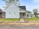 Charming light blue single-story home with a covered porch and well-maintained yard at 917 S Grant St, Muncie, IN 47302