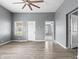 Open-concept living room with wood floors, a ceiling fan, and neutral paint at 917 S Grant St, Muncie, IN 47302