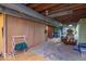 Basement storage area featuring wood-paneled walls and exposed ceilings at 1021 N Bolton Ave, Indianapolis, IN 46219