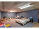 Finished basement area with carpet, blue walls, and ample space for a rec room or playroom at 1021 N Bolton Ave, Indianapolis, IN 46219