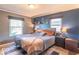 Well-lit bedroom with large windows, a cozy bed, and stylish decor for a relaxing retreat at 1021 N Bolton Ave, Indianapolis, IN 46219