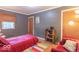 Cozy bedroom with natural light, offering a comfortable bed and a relaxing reading nook at 1021 N Bolton Ave, Indianapolis, IN 46219