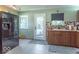 Functional kitchen with stainless steel refrigerator, ample counter space, and convenient back door access at 1021 N Bolton Ave, Indianapolis, IN 46219