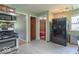 Open kitchen with black refrigerator and stainless steel range and view to the bedrooms at 1021 N Bolton Ave, Indianapolis, IN 46219