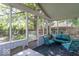 Relaxing screened porch with comfortable seating, offering a view of the lush backyard at 1021 N Bolton Ave, Indianapolis, IN 46219