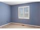 Blue bedroom with natural light from a large window, and carpet at 11 Woodacre Dr, Carmel, IN 46032