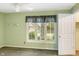 Bedroom with natural light, green walls, large window, and a closet for comfortable living at 11 Woodacre Dr, Carmel, IN 46032