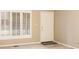 View of a bright entryway with white door, window, and neutral walls and carpet at 11 Woodacre Dr, Carmel, IN 46032