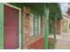 A view of the front of a brick home with green trim and a red screen door at 11 Woodacre Dr, Carmel, IN 46032