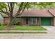 Charming single-story brick home with a well-maintained lawn, red roof, and green trim at 11 Woodacre Dr, Carmel, IN 46032