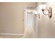 Bright hallway with neutral paint and carpet, as well as sconces and white doors at 11 Woodacre Dr, Carmel, IN 46032