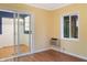 Bright room with wood flooring, a sliding door, and a window AC unit at 11 Woodacre Dr, Carmel, IN 46032