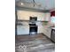 Well-lit kitchen with stainless steel appliances, white cabinetry, and updated countertops at 1102 Branifield Ct, Franklin, IN 46131