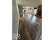 Open floor plan showing the living room leading into the kitchen area with wood floors at 1102 Branifield Ct, Franklin, IN 46131