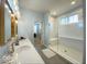 Bathroom features double vanity, modern lighting, and a glass-enclosed shower with a built-in seat at 1115 Freshwater Ln, Cicero, IN 46034