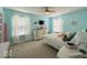 Bright bedroom featuring two windows and neutral walls with a ceiling fan above the bed at 1115 Freshwater Ln, Cicero, IN 46034