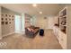 Spacious bonus room with comfortable seating, built-in shelving, and neutral decor at 1115 Freshwater Ln, Cicero, IN 46034