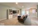 Open and airy bonus room showcasing a cozy seating area, media center, and natural light at 1115 Freshwater Ln, Cicero, IN 46034