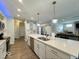 Bright kitchen featuring quartz countertops, stainless steel appliances, and modern pendant lighting at 1115 Freshwater Ln, Cicero, IN 46034