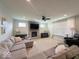 Comfortable living room with stone fireplace, plush seating, and ample natural light at 1115 Freshwater Ln, Cicero, IN 46034