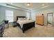 Calming main bedroom with tray ceiling, neutral carpet, and plenty of natural light from multiple windows at 1115 Freshwater Ln, Cicero, IN 46034