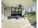 Covered patio with seating, including a hanging chair, and a ceiling fan for comfort at 1115 Freshwater Ln, Cicero, IN 46034