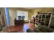 Sunlit bedroom with hardwood floors, and closet space needing attention at 1126 Kings Ct, Indianapolis, IN 46260