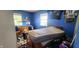 Bedroom with a stacked mattress, two windows and light blue walls at 1126 Kings Ct, Indianapolis, IN 46260