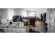 View from the kitchen into the cluttered living room and kitchen area at 1126 Kings Ct, Indianapolis, IN 46260