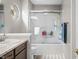 Bright bathroom featuring a shower-tub combo, wood-look flooring, and single sink vanity at 1127 Alydar Cir, Indianapolis, IN 46217