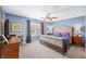 Bedroom with blue walls, carpet, ceiling fan, natural light, and nice furniture at 1127 Alydar Cir, Indianapolis, IN 46217