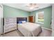 Cozy bedroom with sage walls, a ceiling fan, and a full bed next to a window at 1127 Alydar Cir, Indianapolis, IN 46217