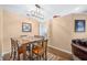 Dining area with wooden table set, modern chandelier, and warm paint tones, creating an inviting ambiance at 1127 Alydar Cir, Indianapolis, IN 46217