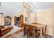 Open dining area with wooden table set, unique light fixture, and seamless connection to the living space at 1127 Alydar Cir, Indianapolis, IN 46217