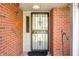 Eye-level view of the front entrance showing a storm door and brick wall at 1127 Alydar Cir, Indianapolis, IN 46217