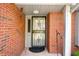Inviting front entrance with a secure storm door, brick columns, and overhead lighting at 1127 Alydar Cir, Indianapolis, IN 46217