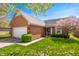 Inviting single-story brick home with manicured front lawn, mature landscaping, and an attached two-car garage at 1127 Alydar Cir, Indianapolis, IN 46217