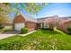 Beautiful brick home with green lawn, blossoming tree, and attached two-car garage, perfect for suburban living at 1127 Alydar Cir, Indianapolis, IN 46217
