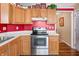 Spacious kitchen features wooden cabinetry, white countertops, stainless steel range and vinyl flooring at 1127 Alydar Cir, Indianapolis, IN 46217