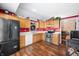 Traditional kitchen with wooden cabinets, stainless steel appliances, and vinyl wood flooring at 1127 Alydar Cir, Indianapolis, IN 46217
