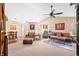 Spacious living room featuring comfortable leather seating, neutral carpeting, and a modern ceiling fan at 1127 Alydar Cir, Indianapolis, IN 46217