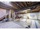 Unfinished basement with exposed wood framing, concrete flooring, and visible utilities, offering potential for customization at 11592 Saltford Ln, Fishers, IN 46037