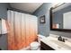 Cozy bathroom featuring a shower with patterned curtain, a single vanity, and neutral tile at 11592 Saltford Ln, Fishers, IN 46037