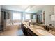 Bright bathroom boasts double sinks with granite countertops and black hardware, plus a luxurious soaking tub and shower at 11592 Saltford Ln, Fishers, IN 46037